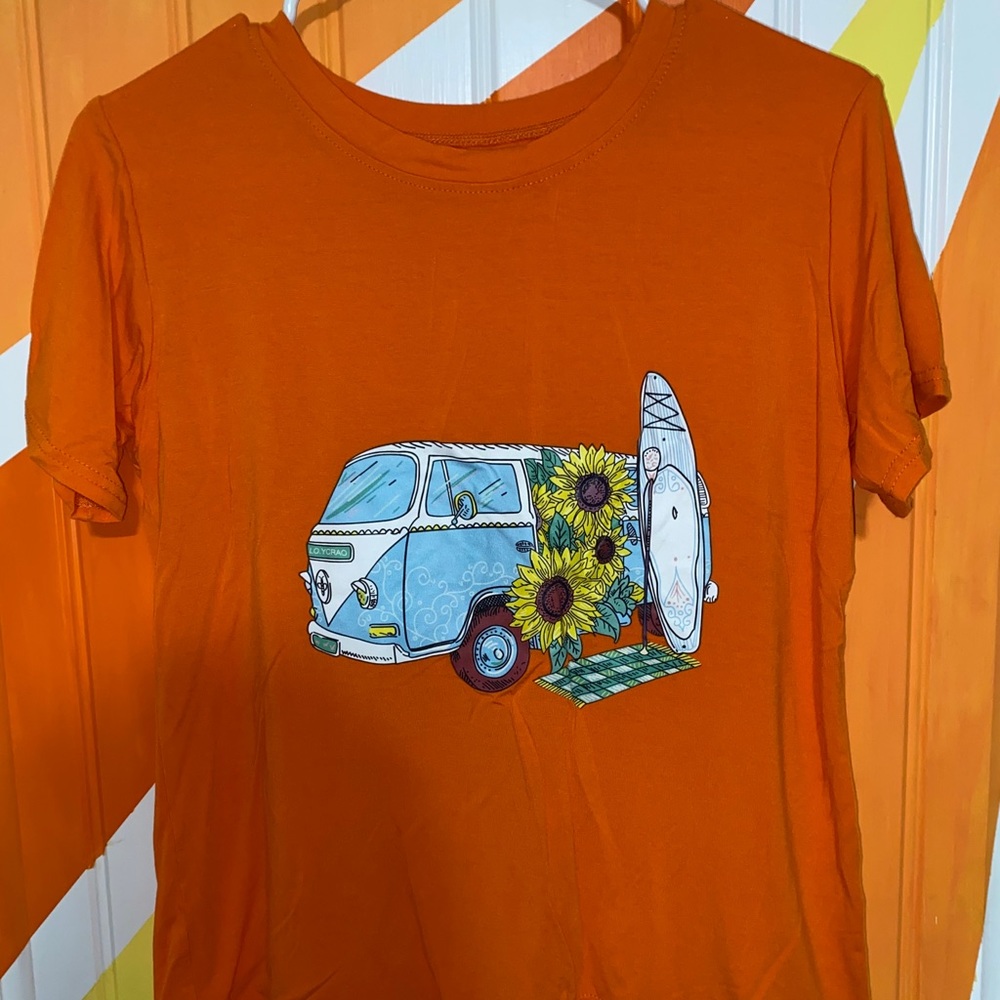 Orange tee shirt with a picture on the front side